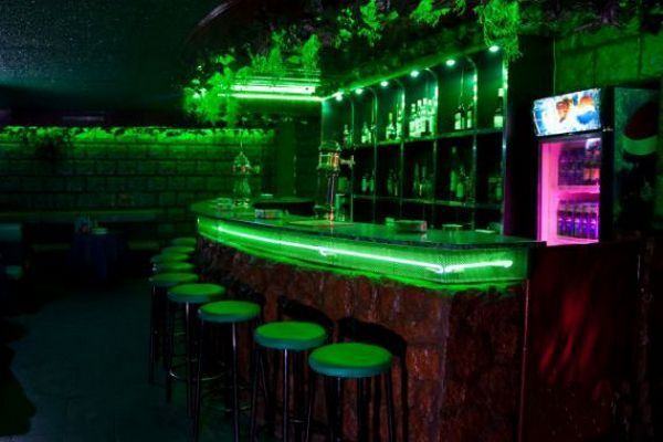 Подсвеченный зеленым бар в Skyroom 