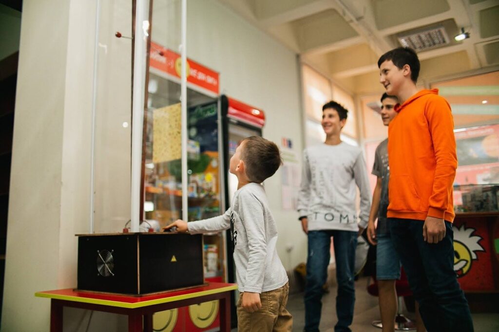 Діти в музеї цікавої науки та техніки вивчають експонат